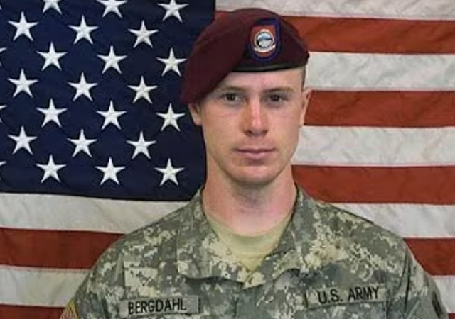 Bowe Bergdahl in uniform in front of the US flag